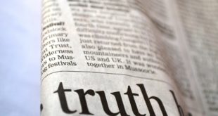 newspaper with word truth written on it