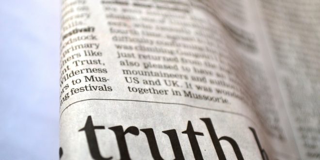 newspaper with word truth written on it