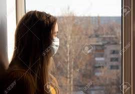 A Girl In A Mask Sits On The Windowsill And Looks Out The Window.. Stock  Photo, Picture And Royalty Free Image. Image 147263852.